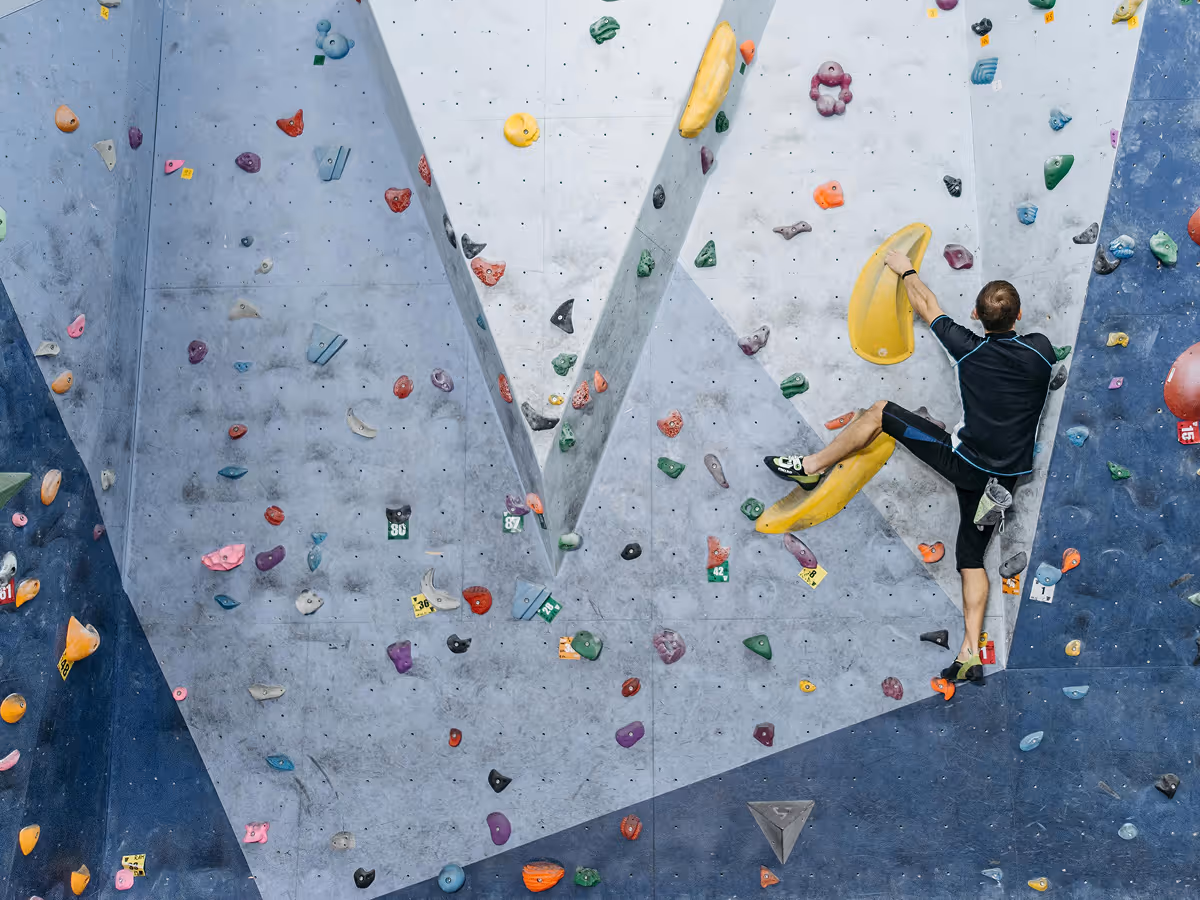 Climber on tall rock wall