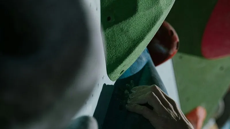 Close up of rock hold and hand