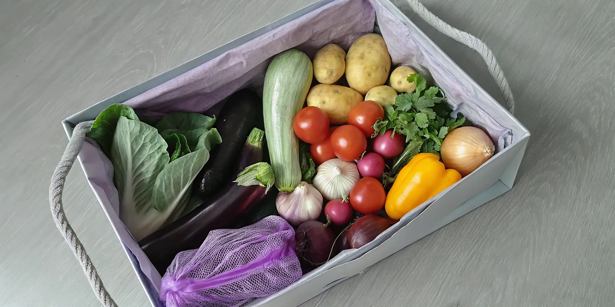 A CSA produce box filled with a variety of fresh, seasonal vegetables.