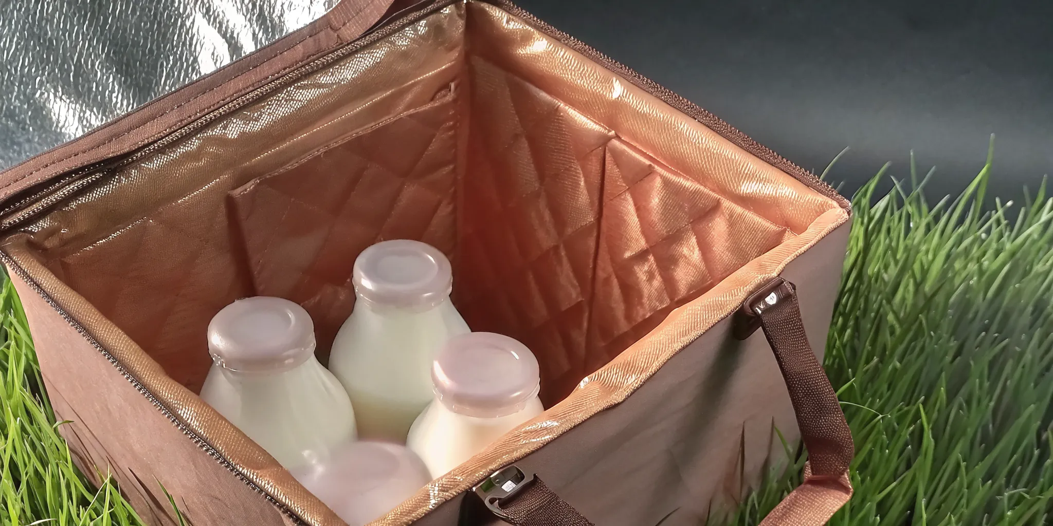 Insulated milk delivery box with glass bottles, keeping milk fresh and secure.