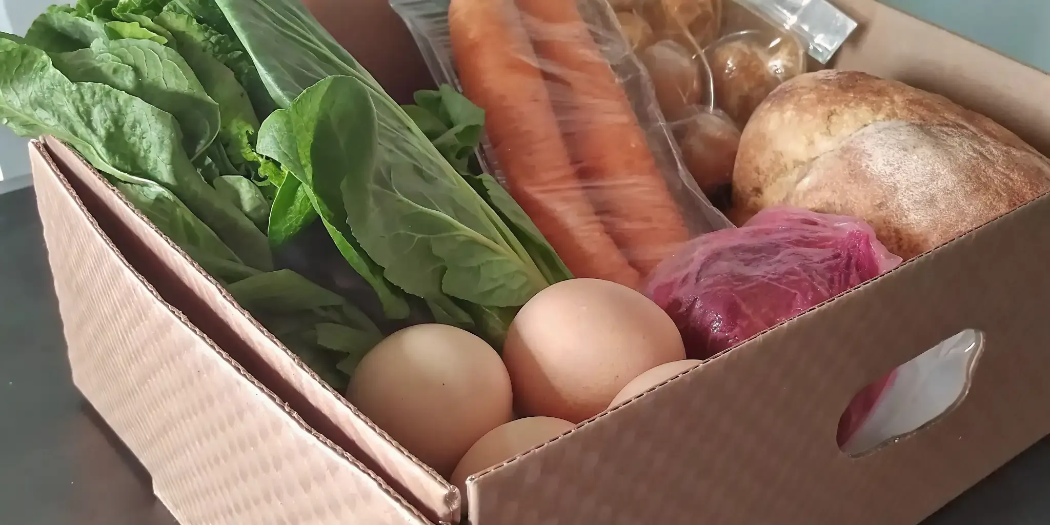 Fresh grocery delivery box with produce, eggs, and bread for Ontario meal planning