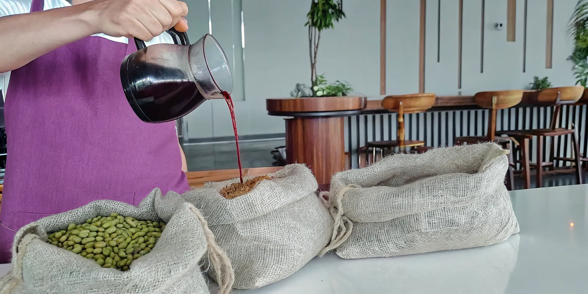 Barista pouring single-origin De Mello craft coffee in a bright Toronto cafe