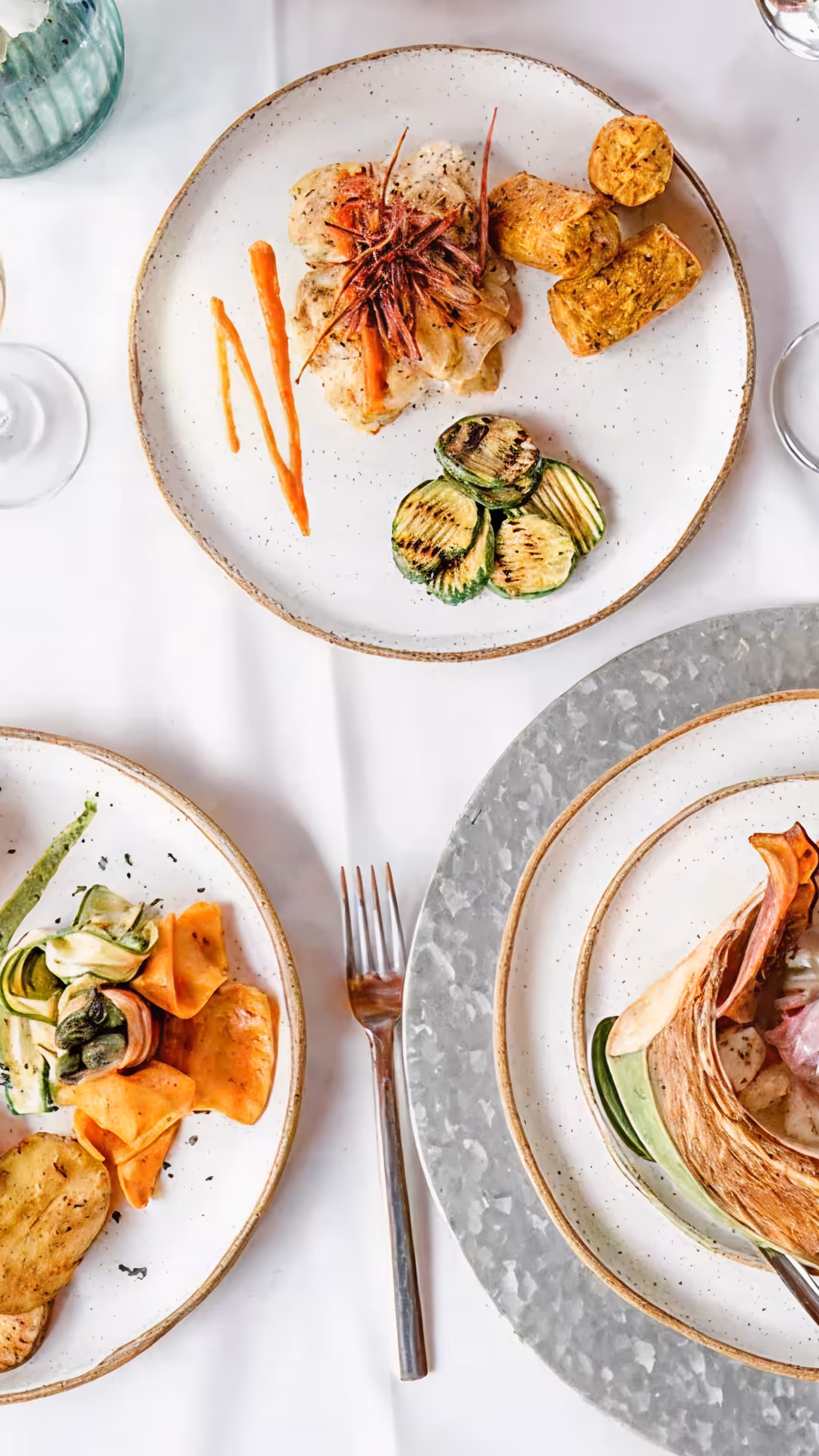 Dining table with gourmet dishes and glasses of white wine at Hacienda La Danesa.