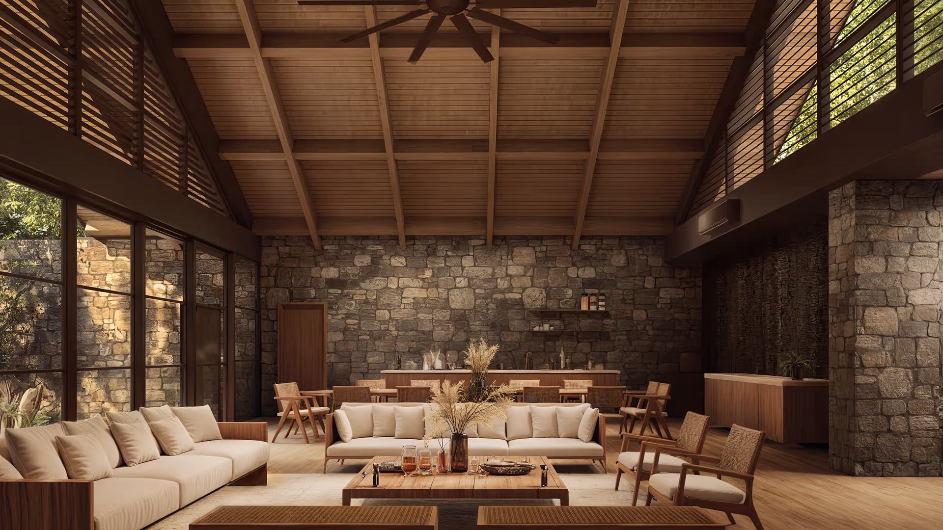 Luxurious lounge at Hacienda La Danesa featuring stone walls and wooden cathedral ceilings.
