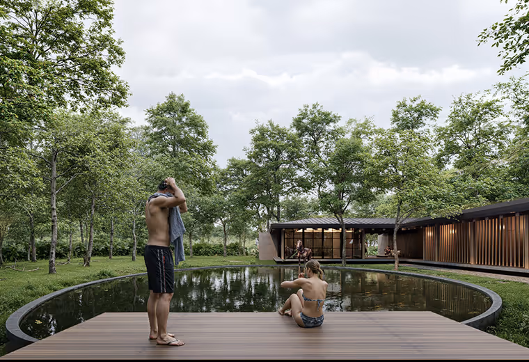 Couple relaxing on a wooden deck by the natural pond at Hacienda La Danesa.