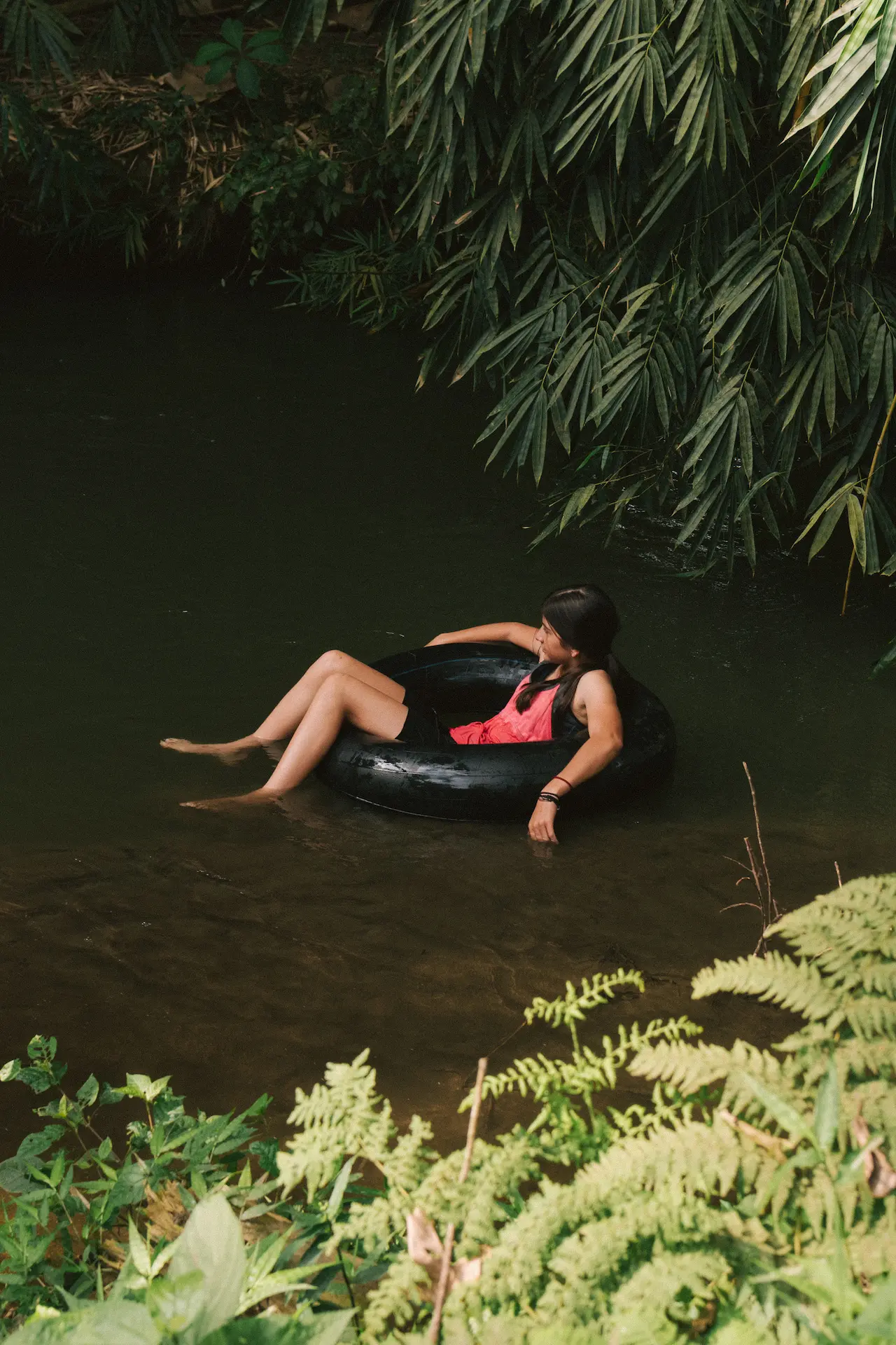 Smiling young woman relaxing in a river tube at Hacienda La Danesa.