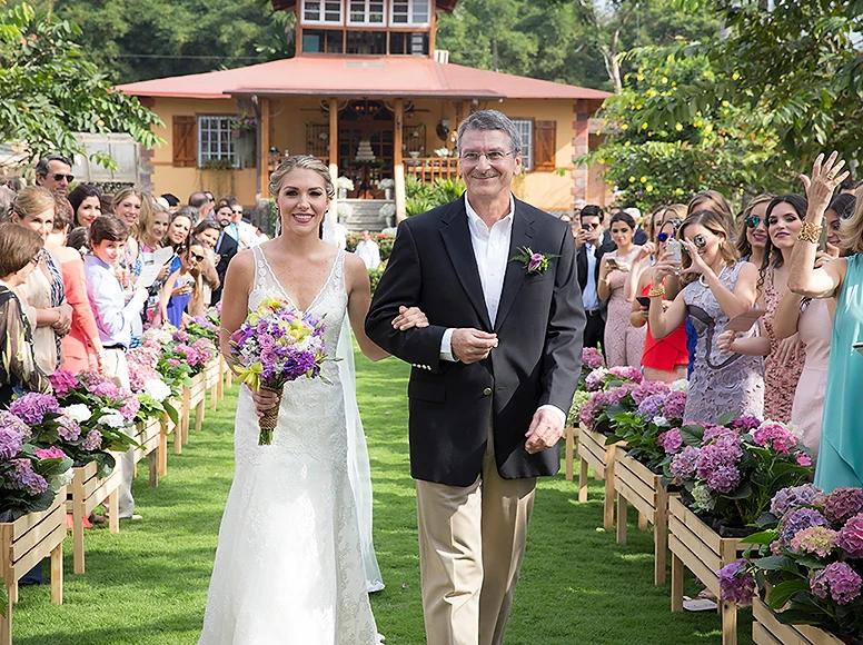 Bride walking the aisle with her father at an outdoor wedding ceremony at Hacienda La Danesa