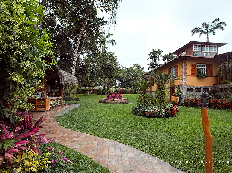 Tropical gardens and historic farmhouse façade at Hacienda La Danesa, Ecuador