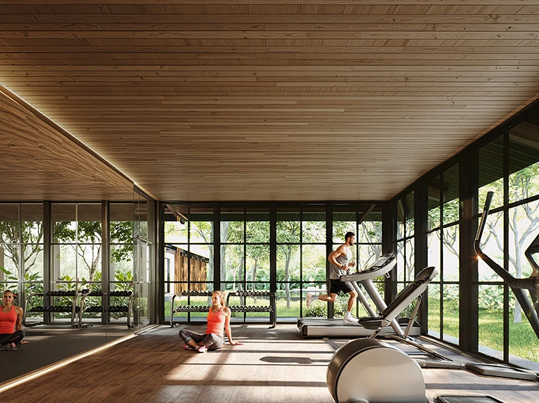 Technogym fitness center at Hacienda La Danesa with glass walls overlooking tropical gardens