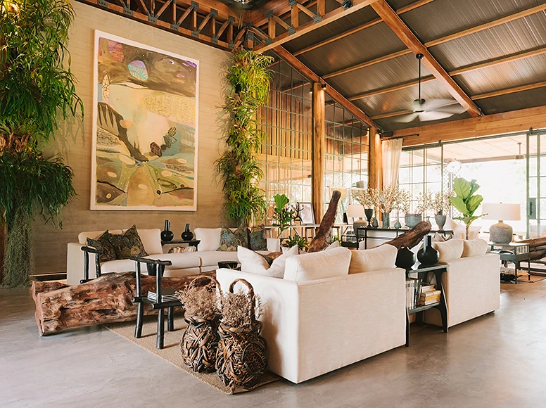 Open lounge at Hacienda La Danesa with linen sofas, tropical plants and contemporary artwork