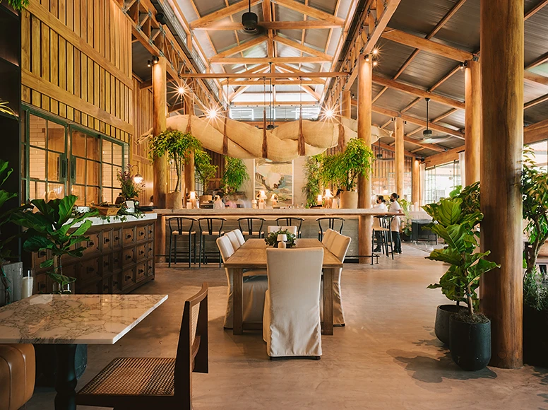 Helge Restaurant at Hacienda La Danesa with wood beam ceiling and tropical plants