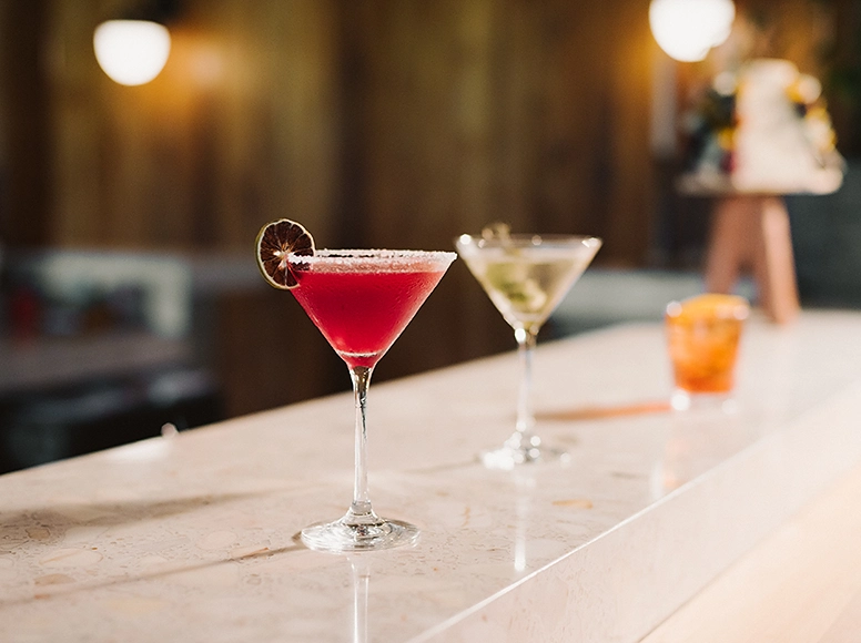 Signature cocktails on the bar at Hacienda La Danesa, including a blood orange martini