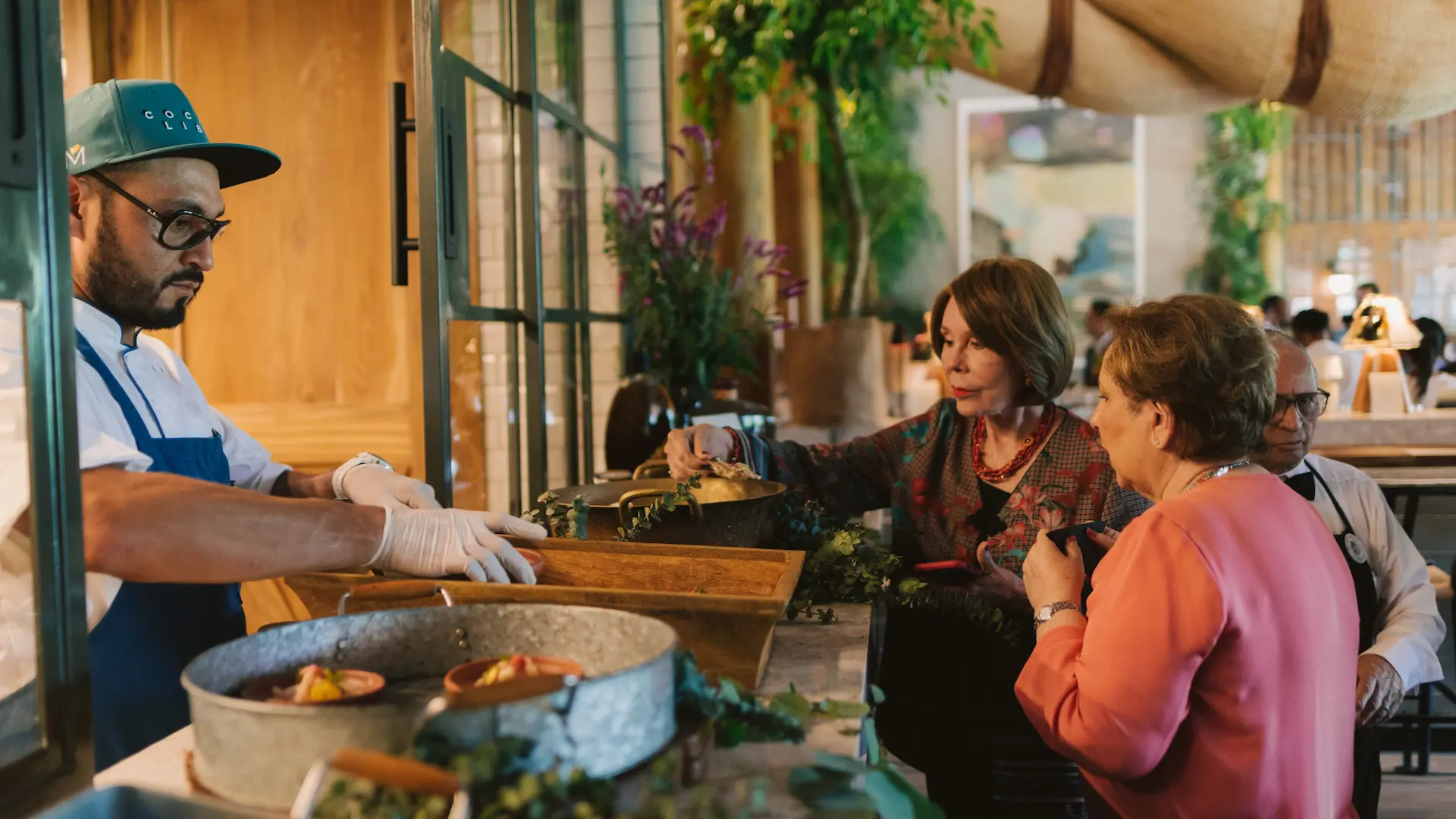 Guest participating in a hands-on culinary or floral workshop at Hacienda La Danesa