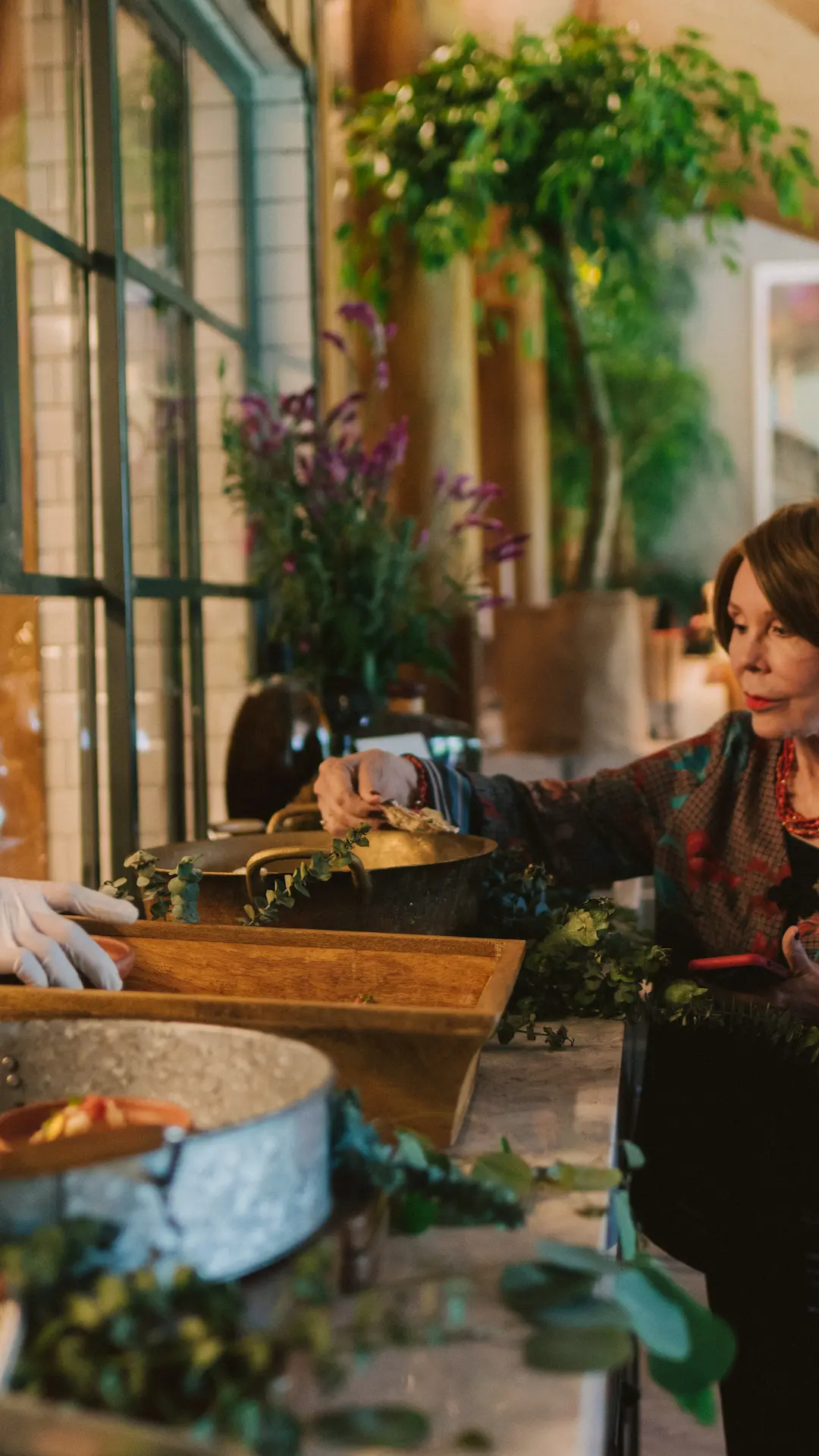 Guest participating in a hands-on culinary or floral workshop at Hacienda La Danesa