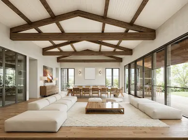 Bright open-plan living room at Hacienda La Danesa private residence with vaulted beamed ceiling, white sectional sofa and panoramic glass doors to the garden