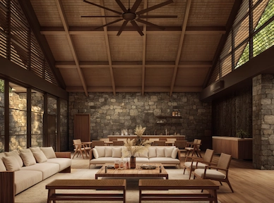 Spacious private residence living room with stone walls at Hacienda la Danesa, vaulted wood ceiling, large windows, neutral seating, and warm natural finishes.