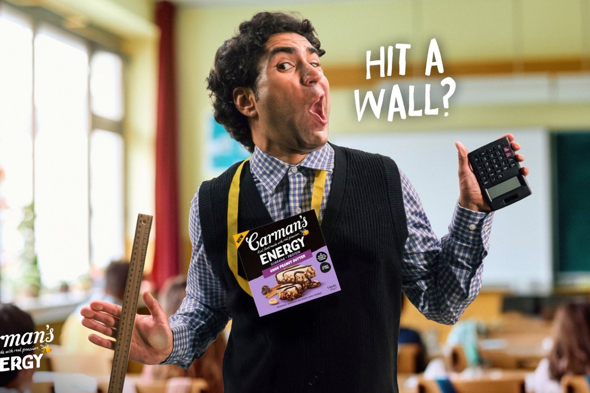 Carman's Energy Hit A Wall campaign still of a teacher holding an Energy bar