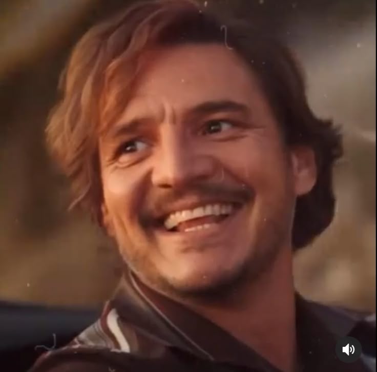 Smiling man with tousled hair in a leather jacket
