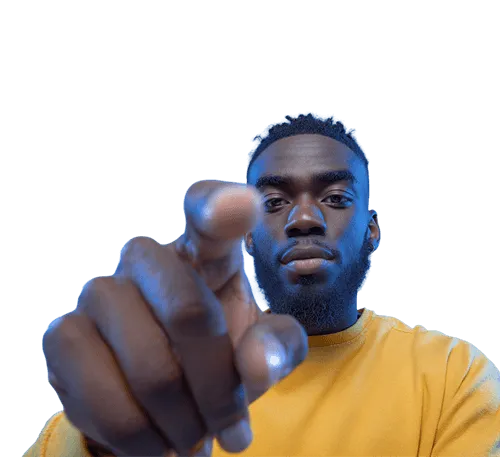 Close-up of a man with a beard wearing a yellow shirt pointing directly at the camera.