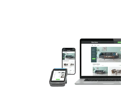 Laptop, smartphone, and card payment device displaying an online furniture shopping website with a gray sofa and wooden table.