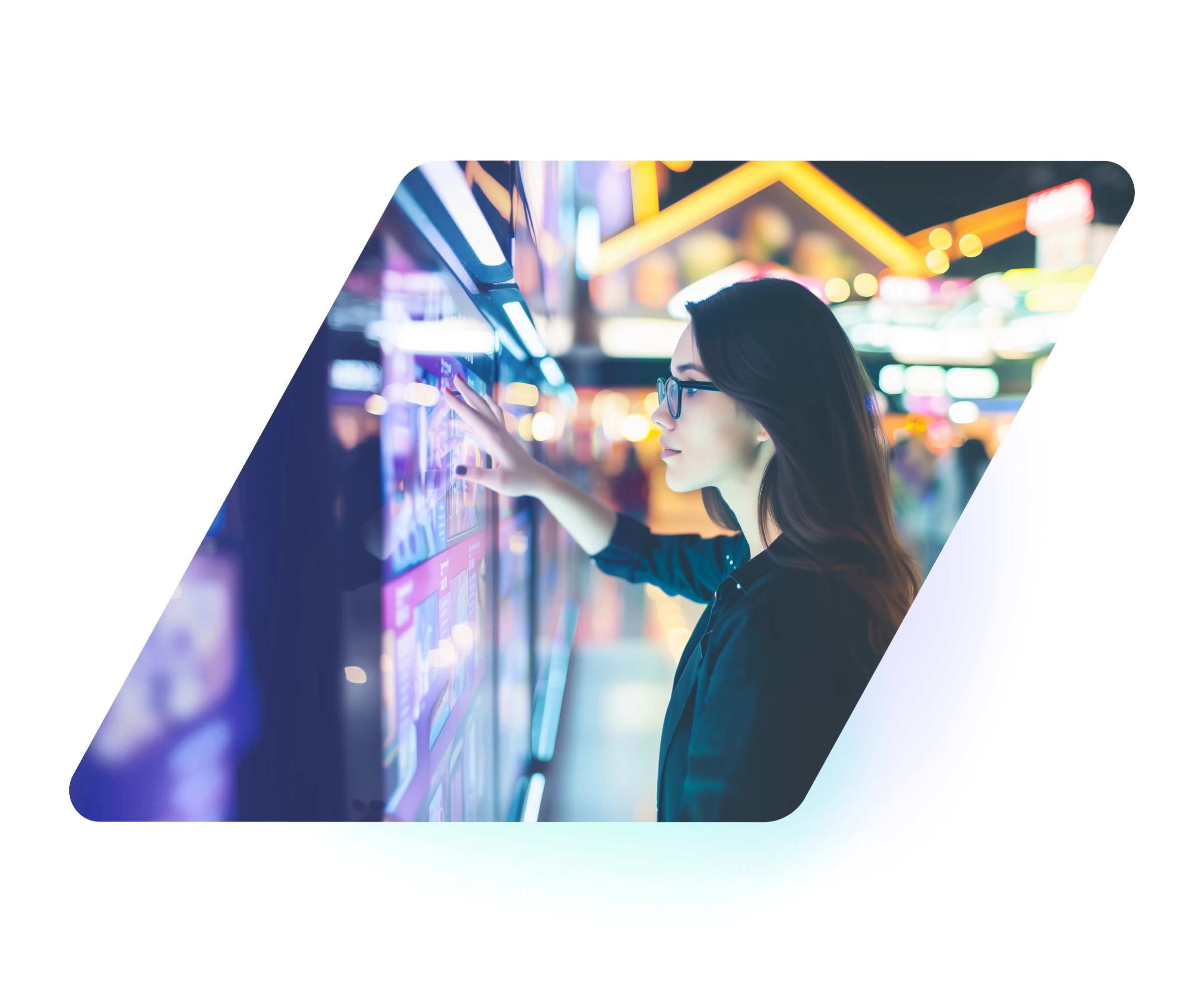 Young woman wearing glasses interacting with a digital touchscreen in a brightly lit urban setting at night.