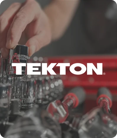 Close-up of a hand selecting a Tekton socket wrench from a tool set with Tekton logo overlay.