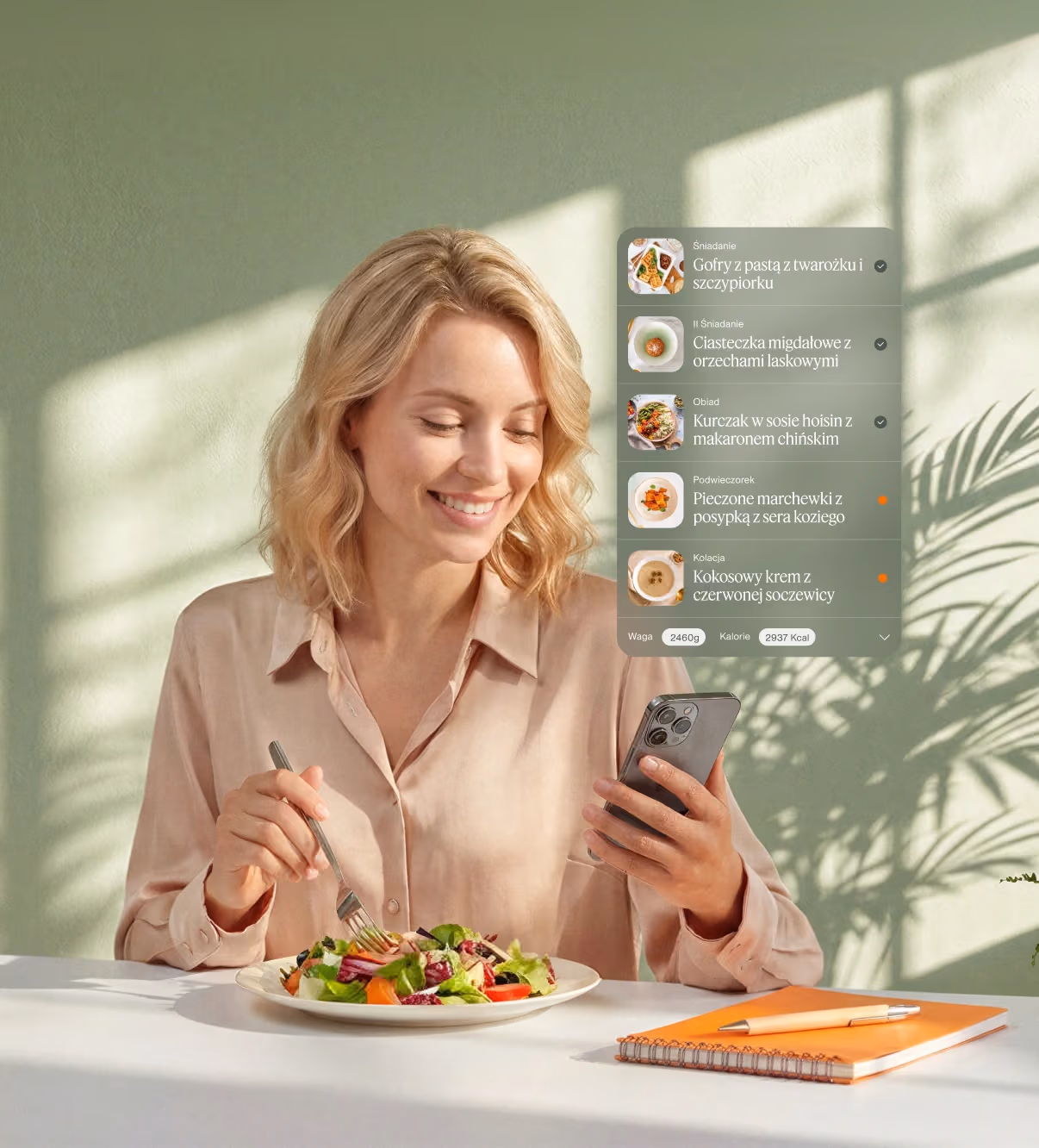 A women looking at app with meal tracker while eating salad