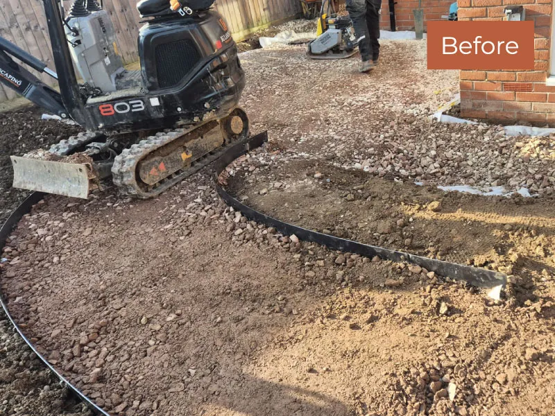 Gravel and dirt surface with a metal edging strip and a compact excavator on a landscaping site marked 'Before'.