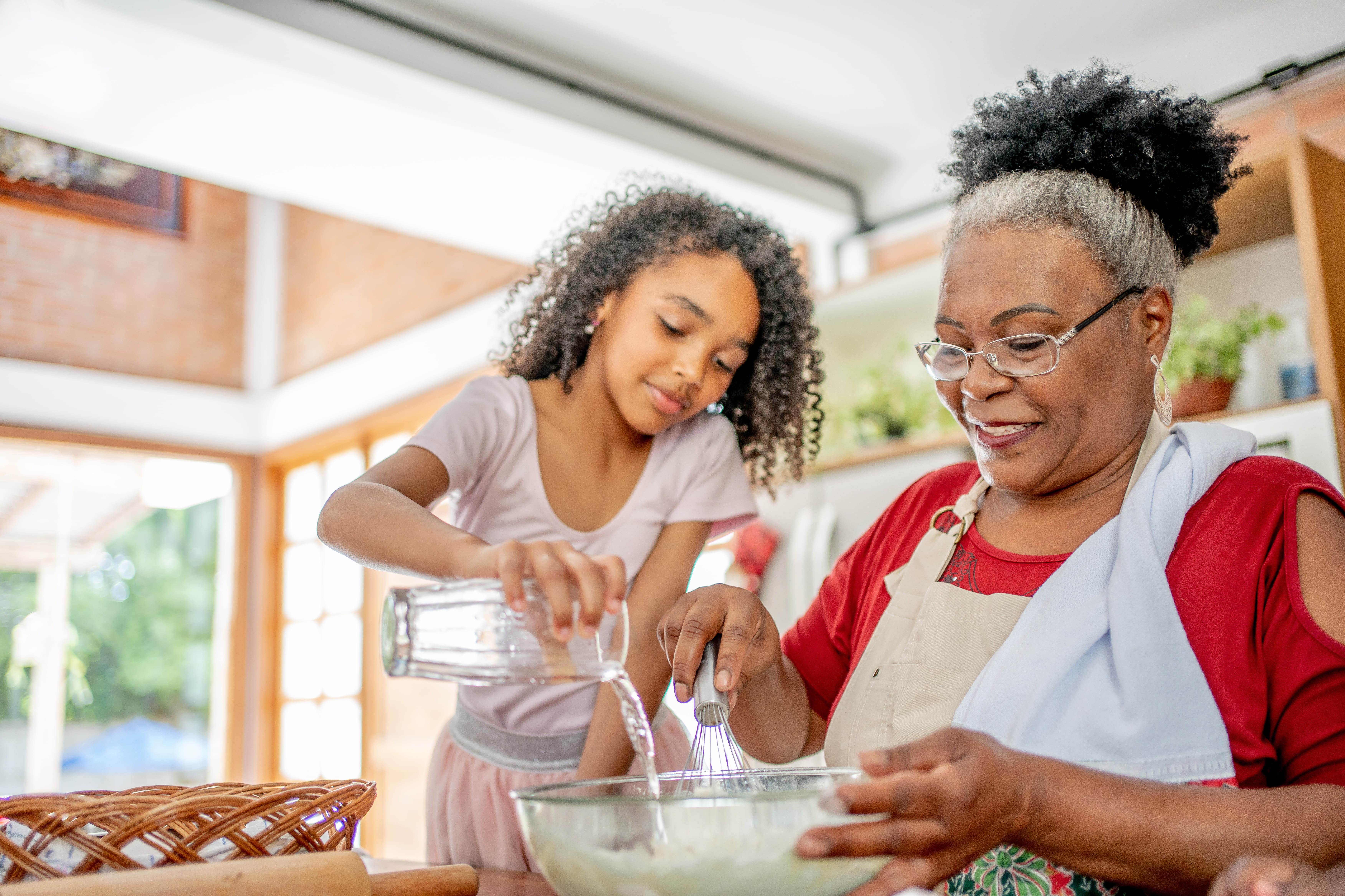 grandmother and granddaughter baking together and preserving recipes and memories through generations in a digital capsule