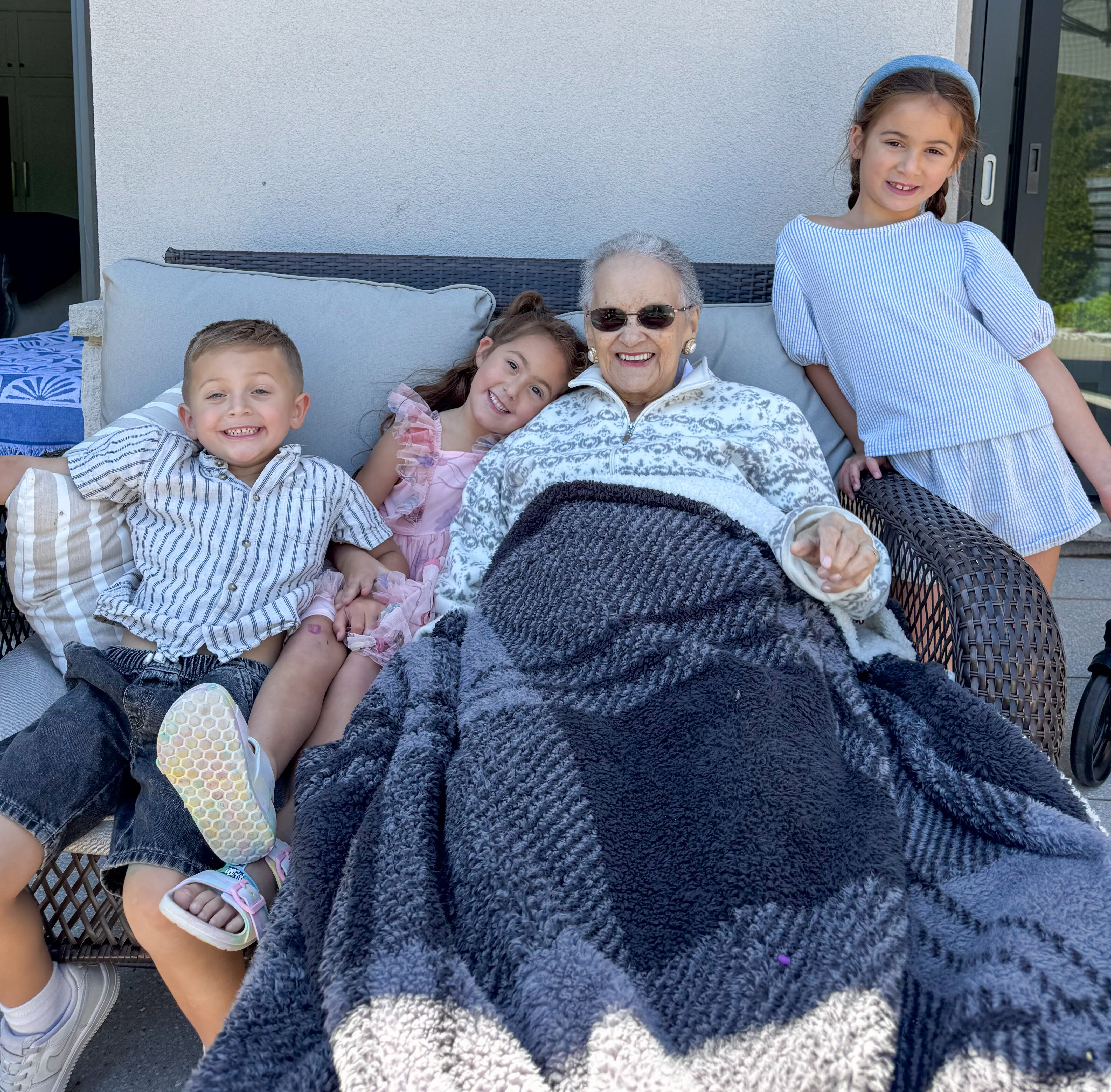 A family photo of a granny with her 3 grandchildren preserved in a digital memory capsule