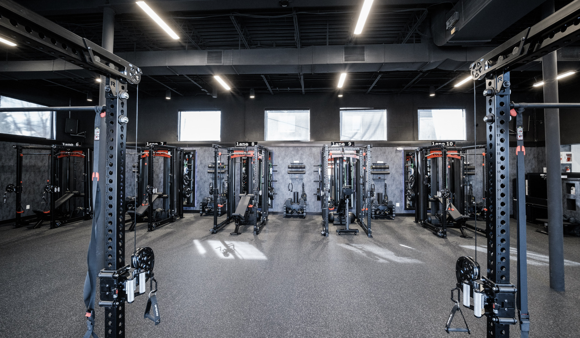 Empty TRAIN Training House™ featuring multiple private SpecLanes™ with best-in-class equipment arranged in a clean, symmetrical layout, designed for focused one-on-one Reserved Training™ with no crowds or shared space.