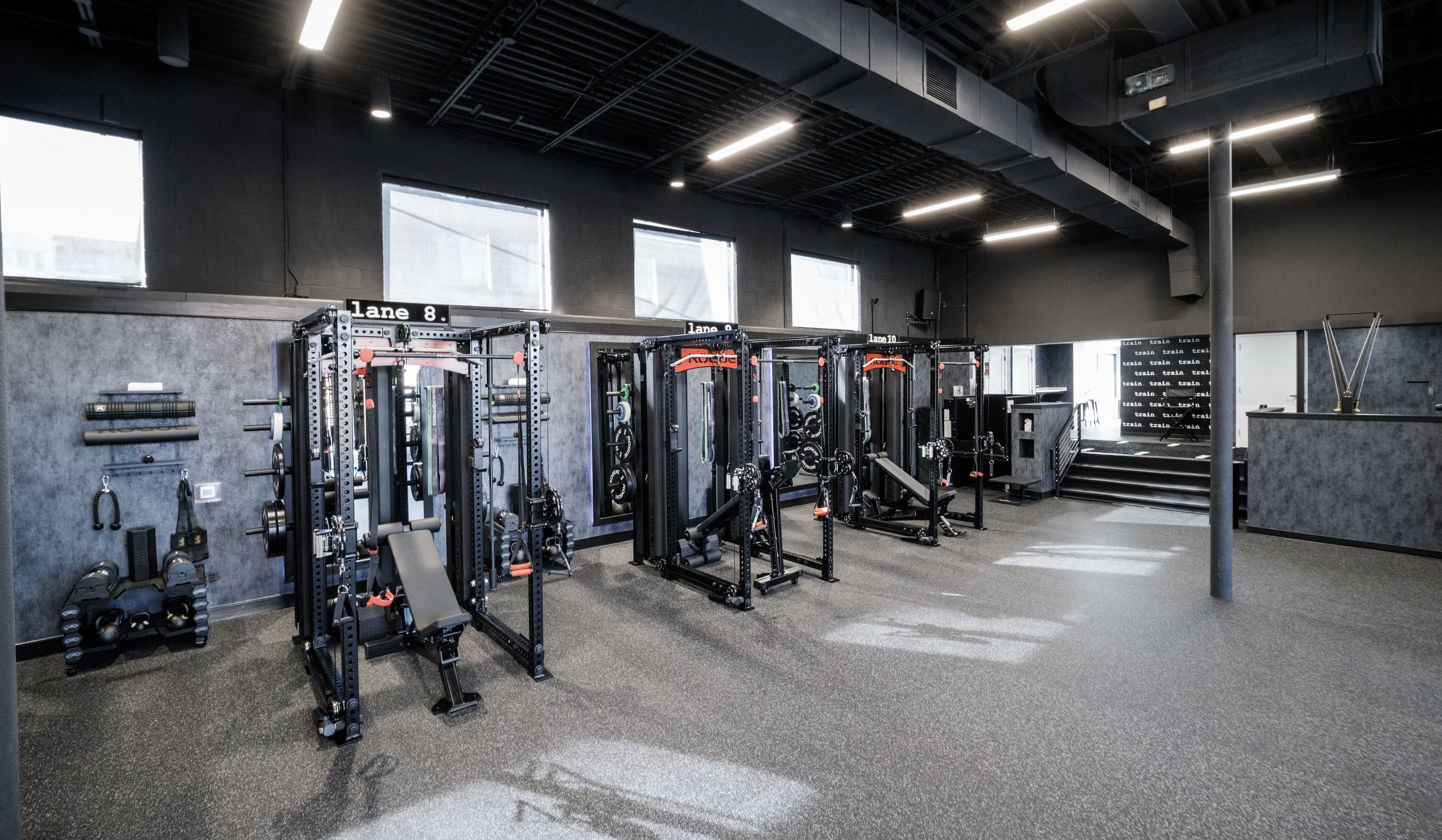 Wide view of a TRAIN Training House™ with multiple private SpecLanes™ fully equipped with best-in-class equipment, arranged in a clean, open layout for focused one-on-one Reserved Training™ without crowds or shared space.