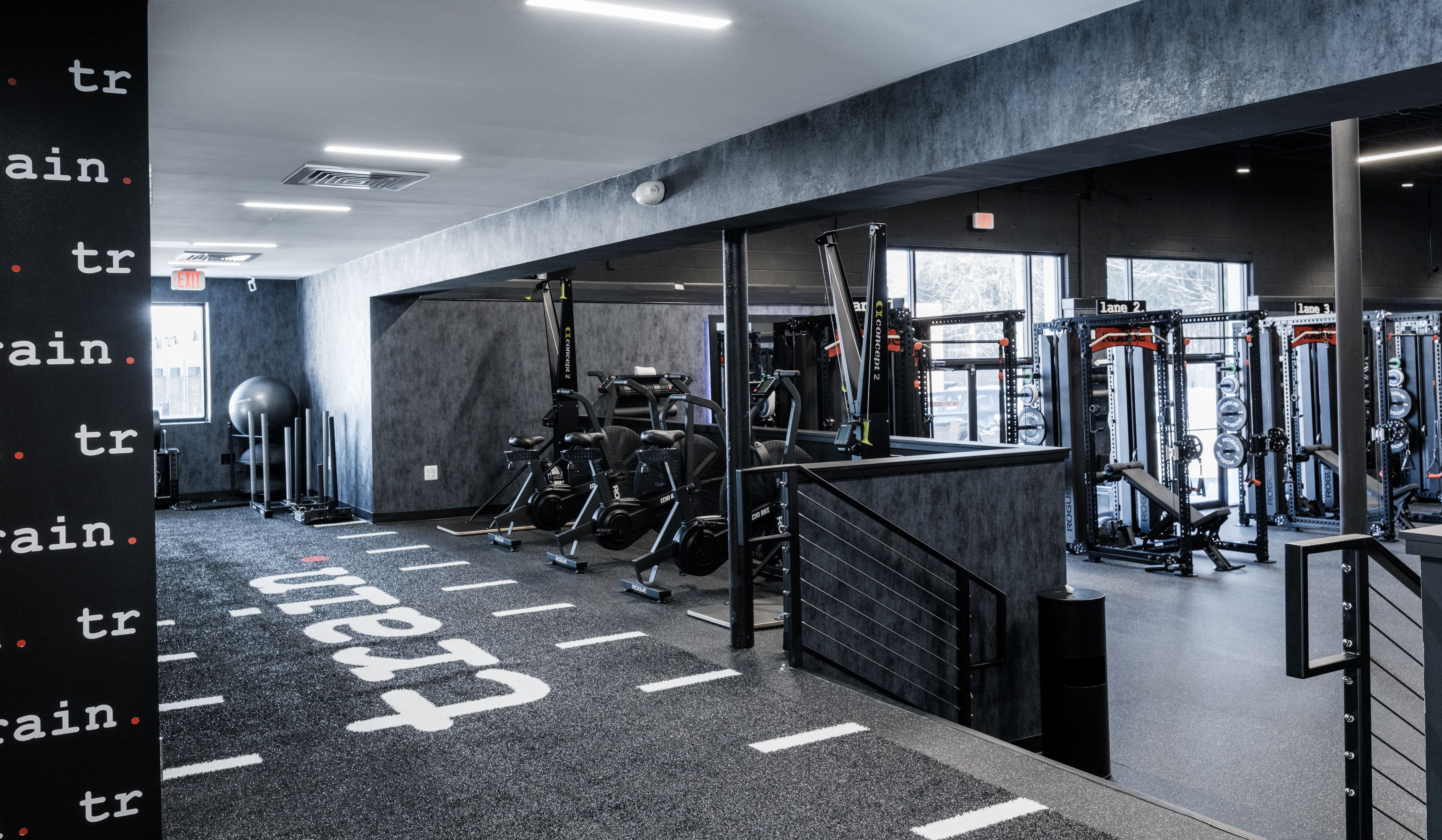 Interior of a TRAIN Training House™ featuring a turf training area and adjacent private SpecLanes™, with best-in-class equipment in a clean, controlled environment designed for focused one-on-one Reserved Training™ without crowds or shared space.