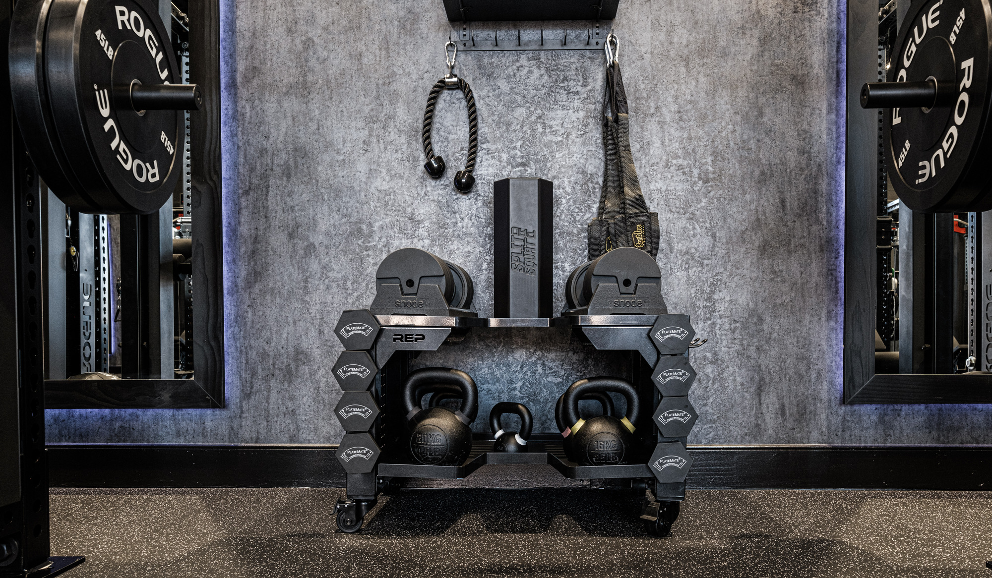 Detail view of a fully equipped SpecLane™ at TRAIN, featuring organized kettlebells, adjustable dumbbells, and best-in-class equipment in a clean, private setup designed for focused one-on-one Reserved Training™.