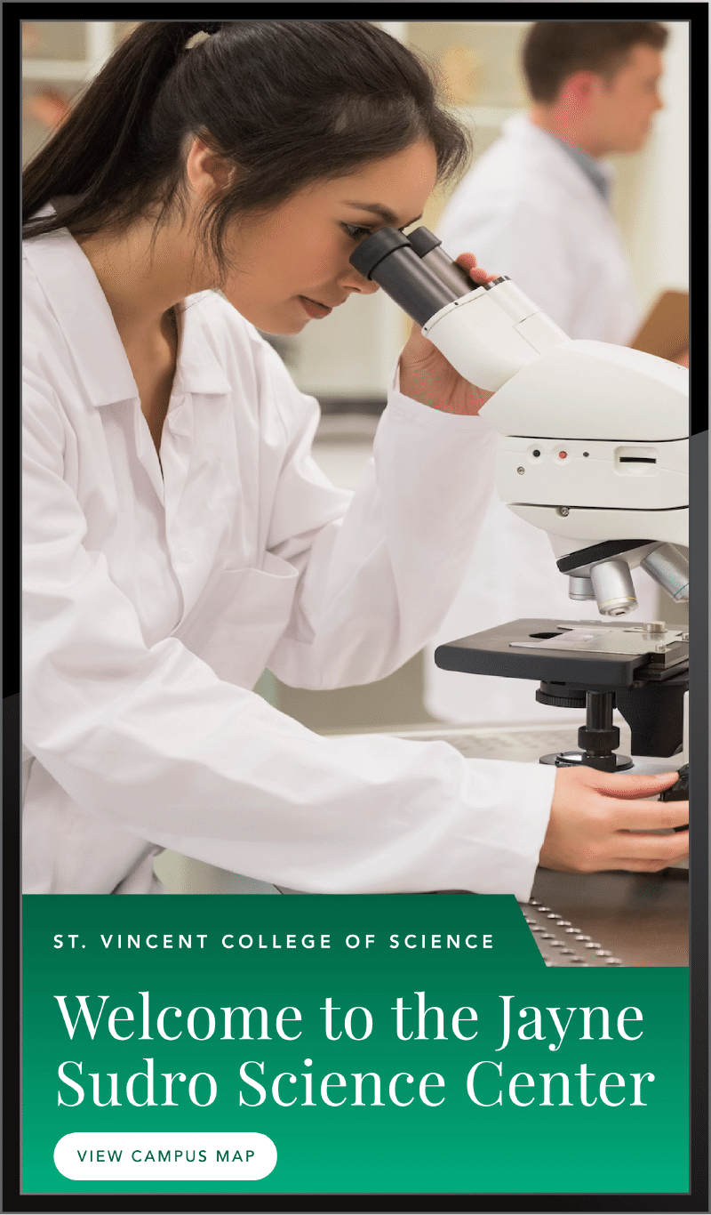 Student using a microscope in lab