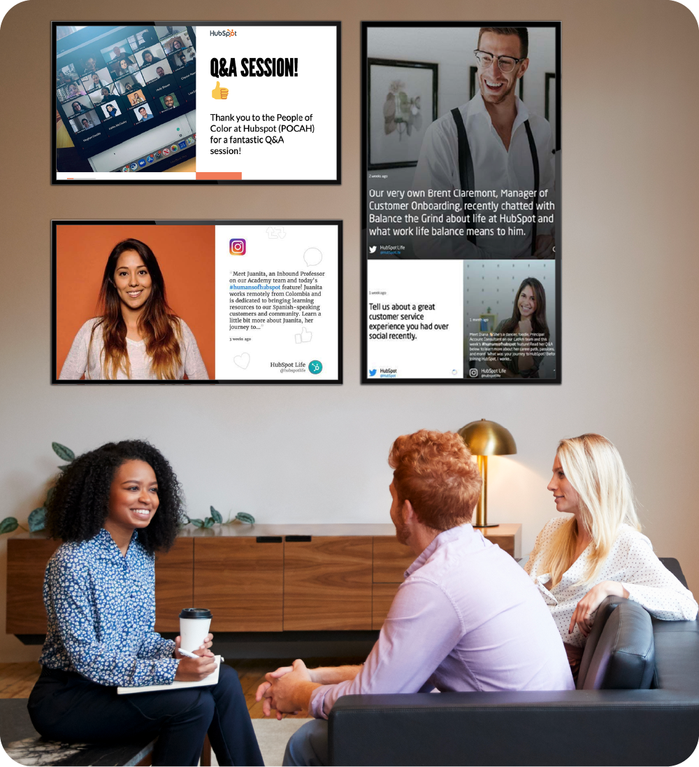 Colleagues meeting in a modern office with digital signage screens on the wall