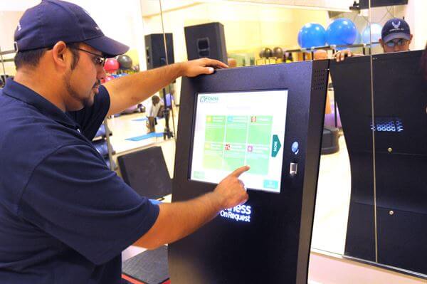 Man using a self-service kiosk at a gym or hardware store