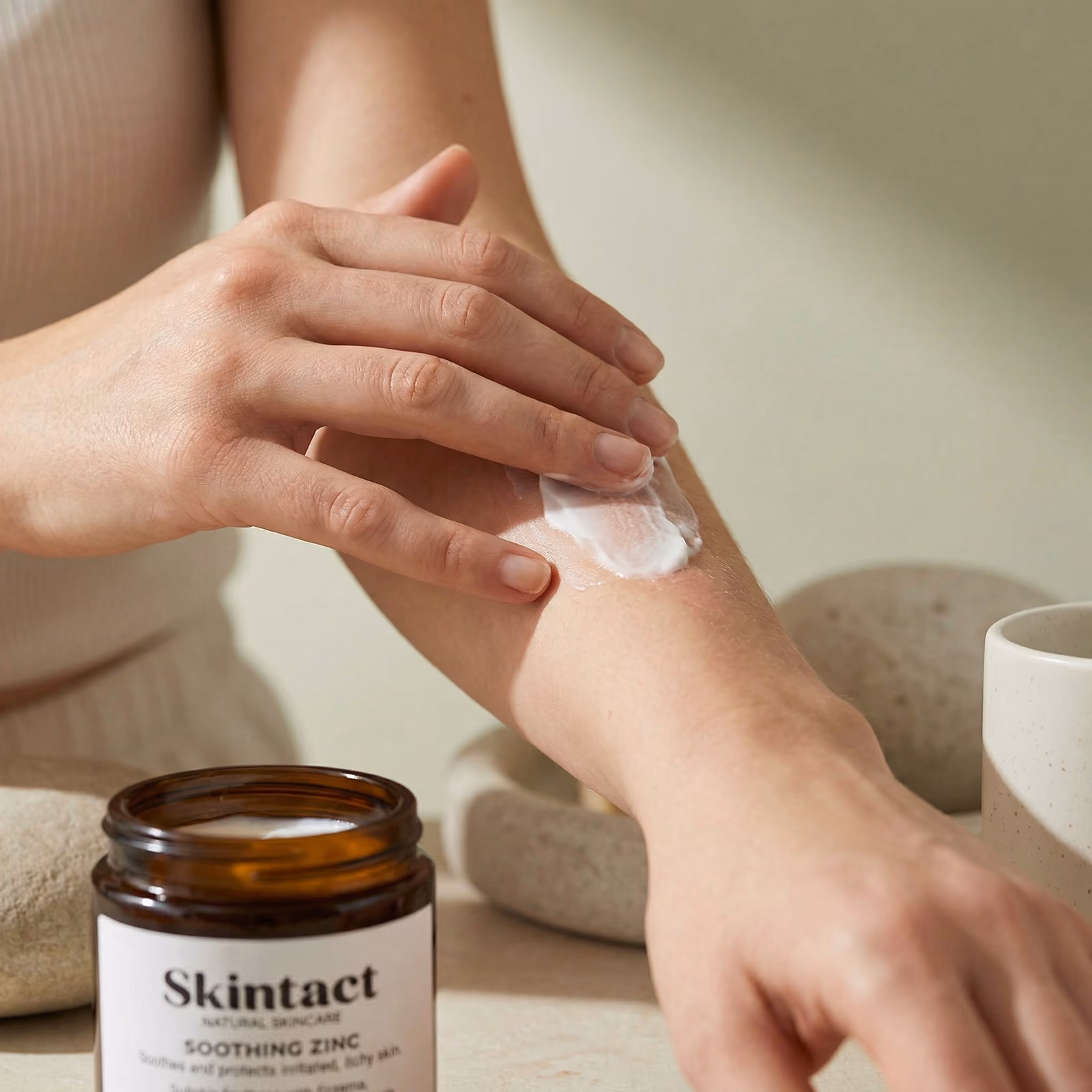 A lady applying cream to her arm