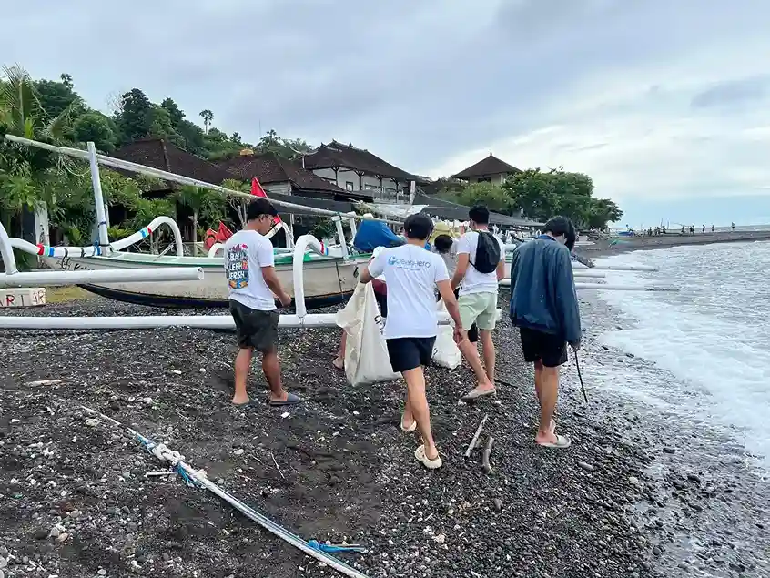 OceanHero volunteers collecting beach debris during a shoreline cleanup event in Amed, Bali