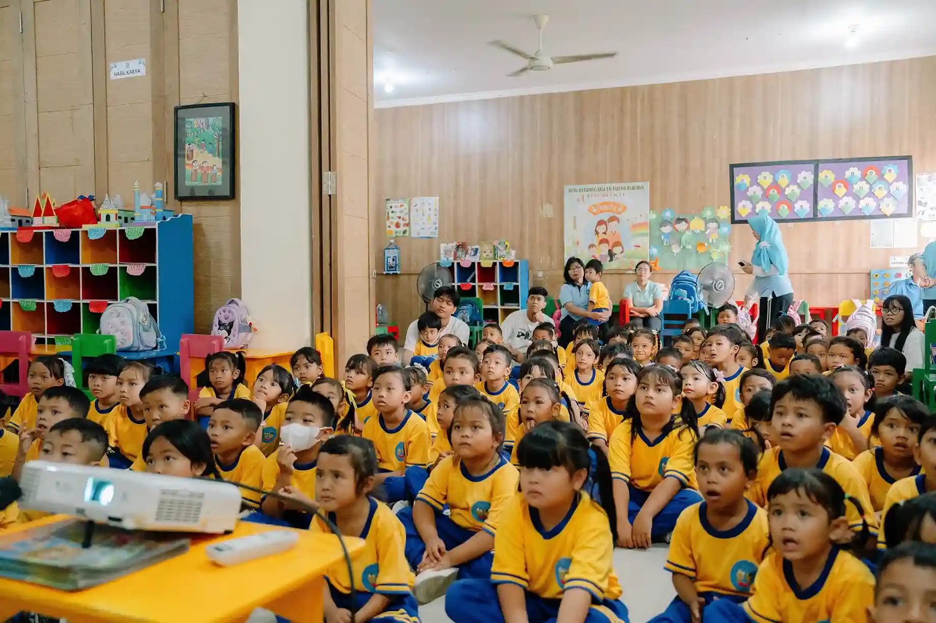 Young students in yellow uniforms gathered at TK Putra Budaya for World Clean Up Day assembly