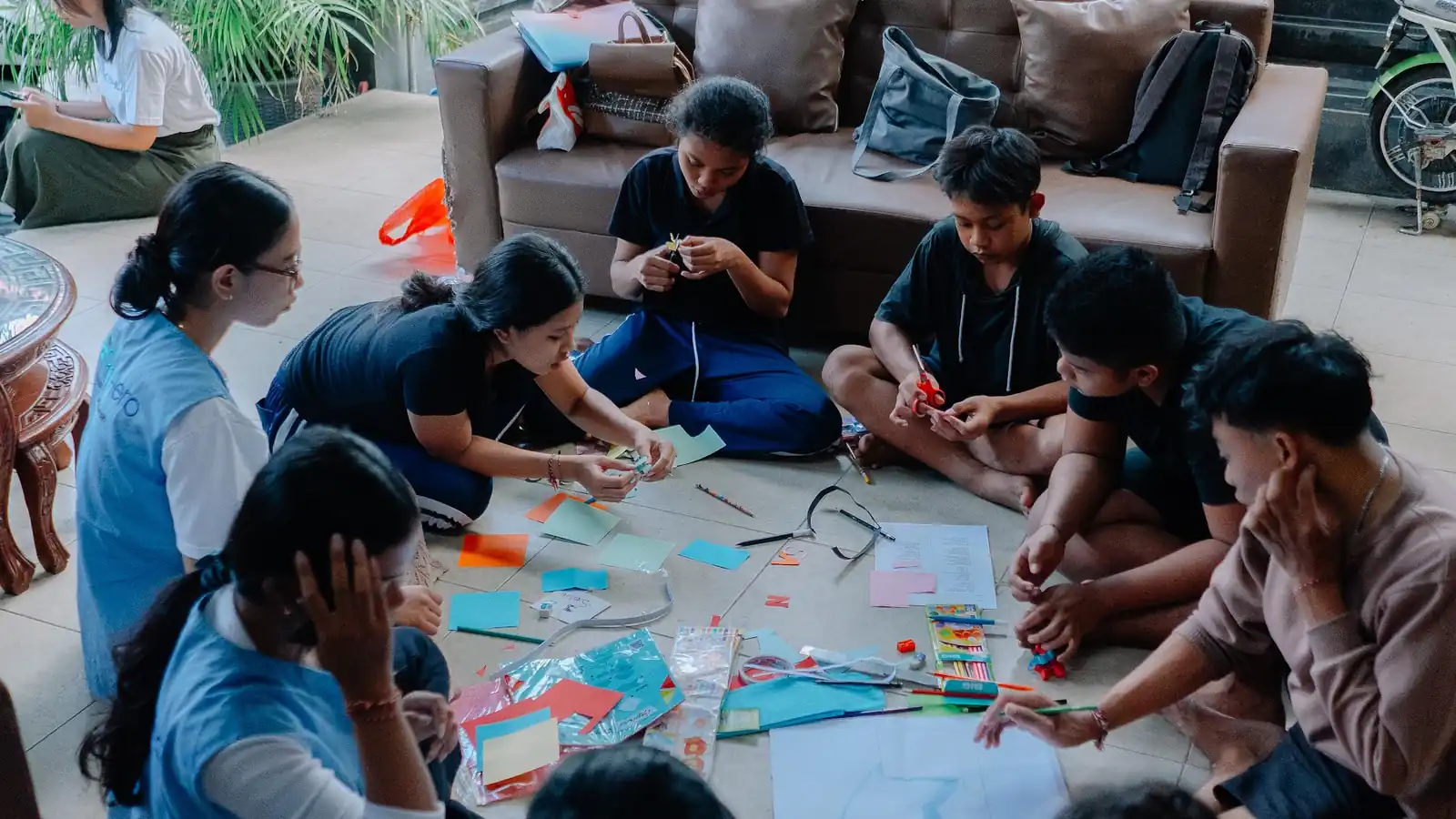 Volunteers and children making crafts from plastic waste at Sunya Giri Orphanage