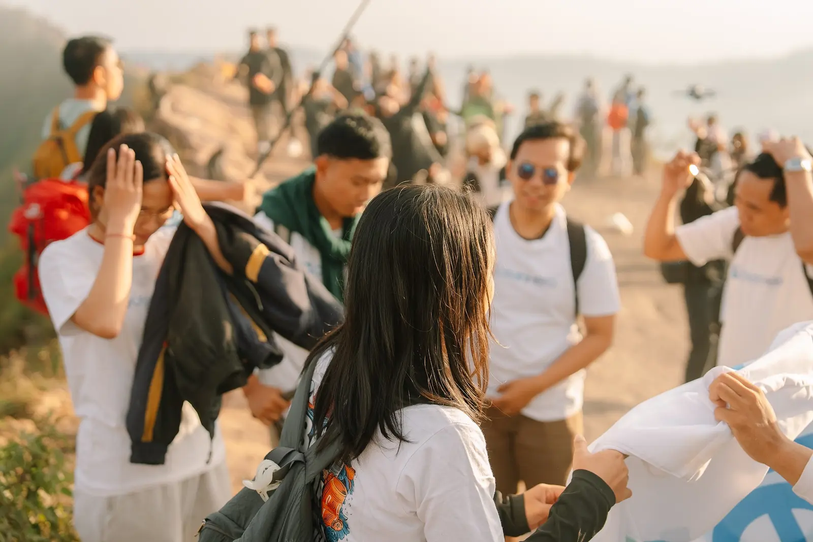 Volunteers handing over collected waste bags at Batur Sunrise Point