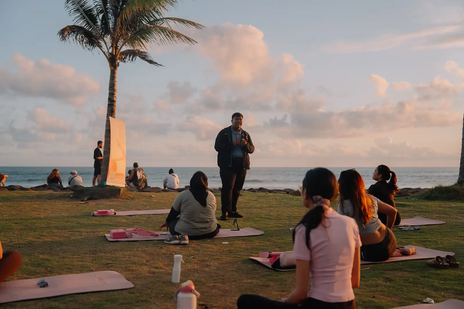 The Pilates group on their mats at sunset after the beach clean-up