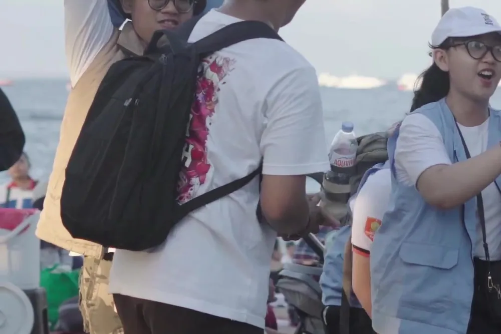 Volunteers walking the shoreline at Sanur Beach