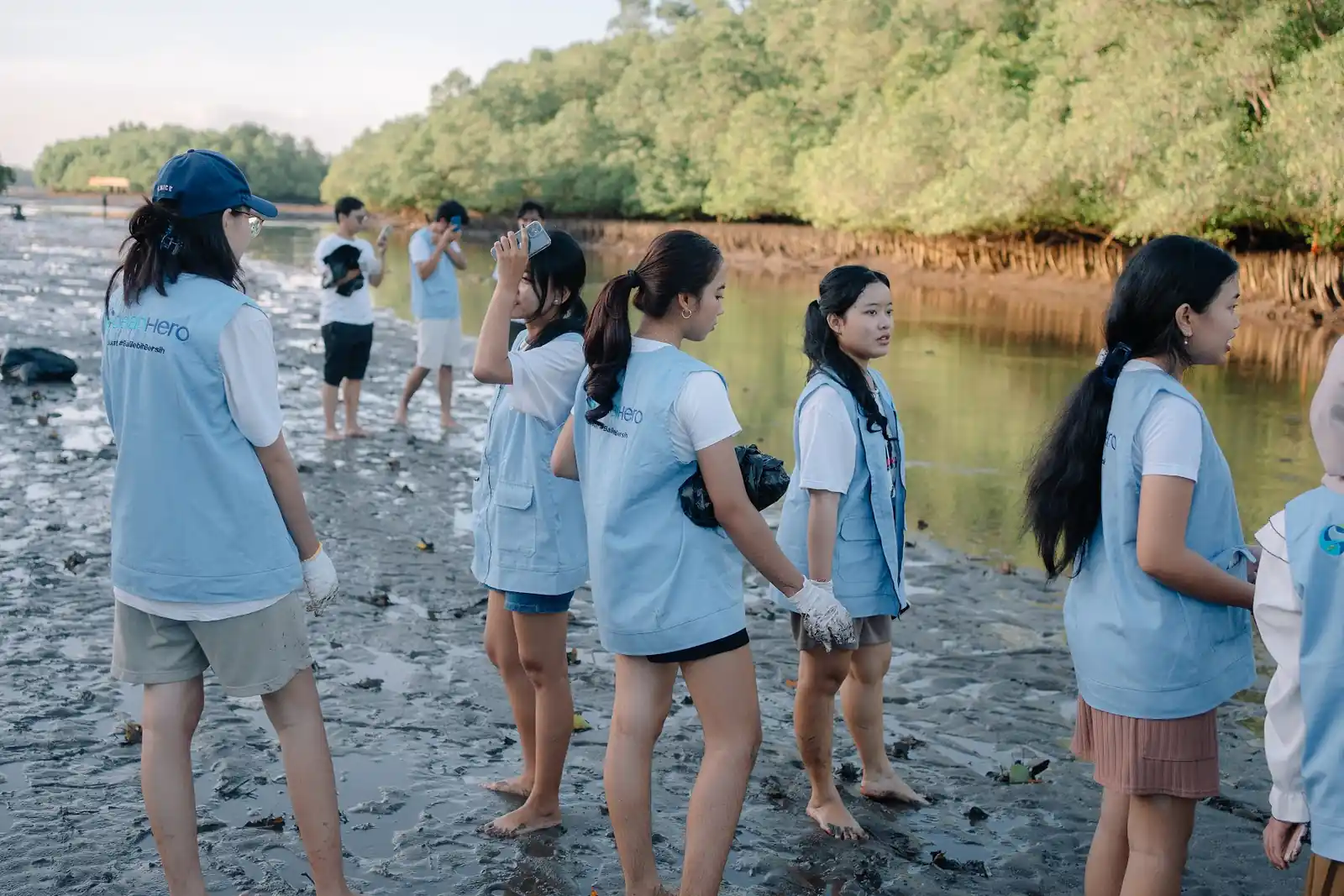 Volunteers working across the mudflats during the Ecomora kickoff
