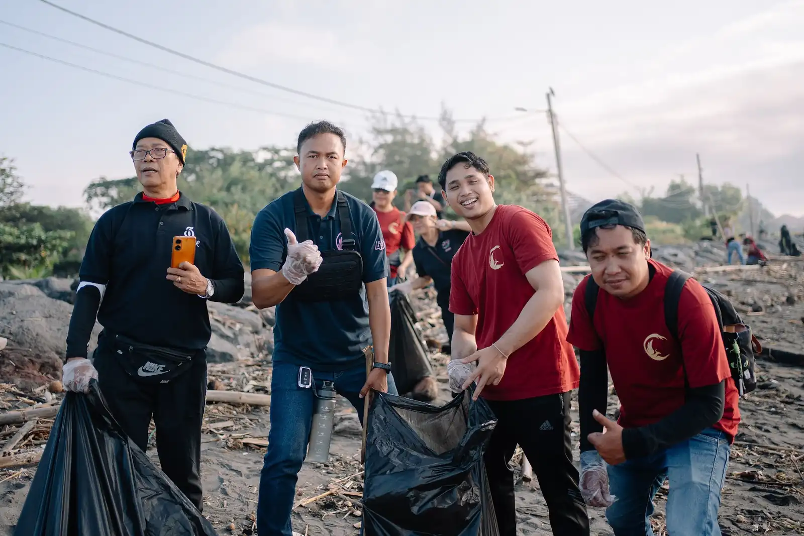 Volunteers with filled waste bags at the end of the clean-up