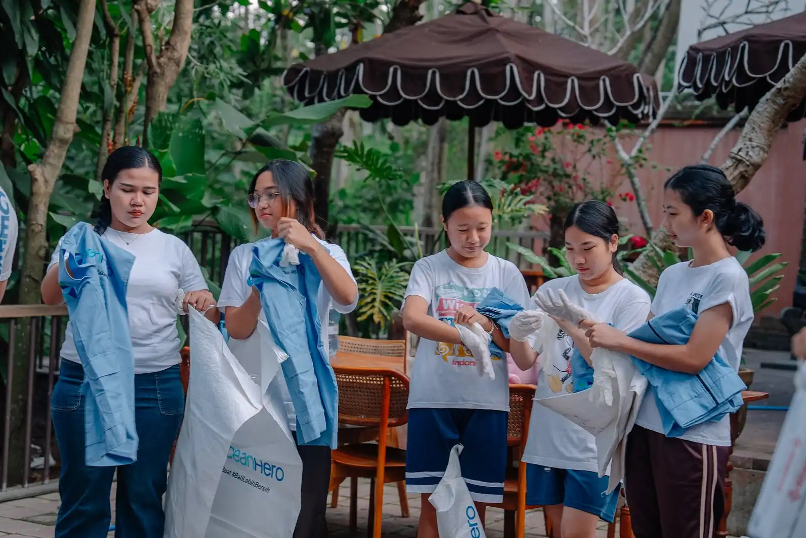 Volunteers handing out sacks and gloves before the clean-up at Alam Wellness