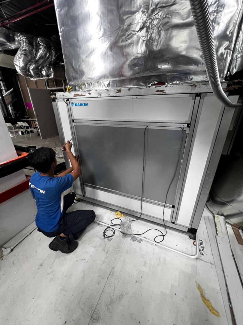 HVAC technician servicing air conditioning system