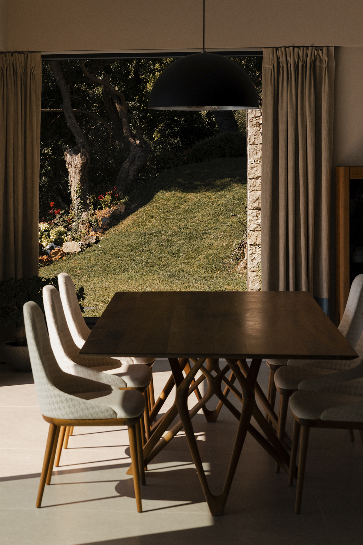 Indoor dining area overlooking the villa garden