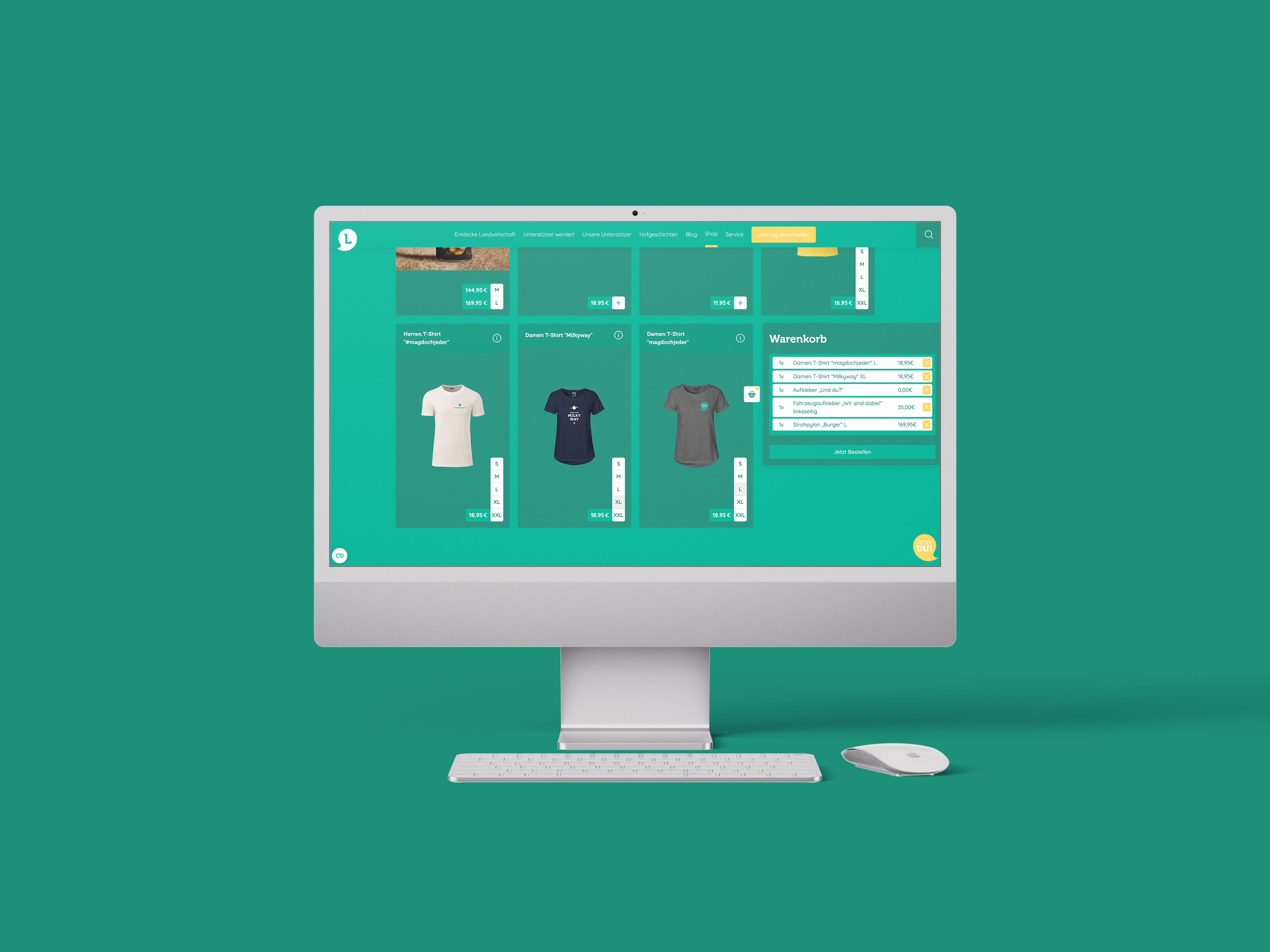 iMac zeigt einen Onlineshop mit T-Shirts und Warenkorb auf grünem Hintergrund.